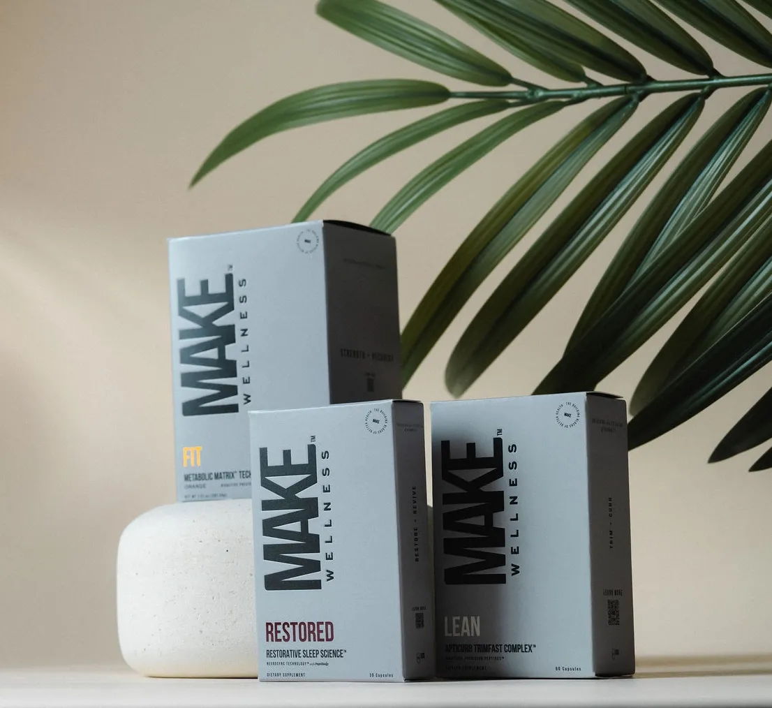 MAKE Wellness peptide boxes — Lean, Fit, Restored — with palm leaf on warm neutral background